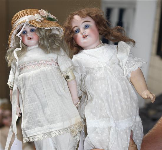 A German doll marked 62, original wig, fixed eyes and wrists, 14in., and a German doll marked 3002 on shoulder plate, bisque arms,